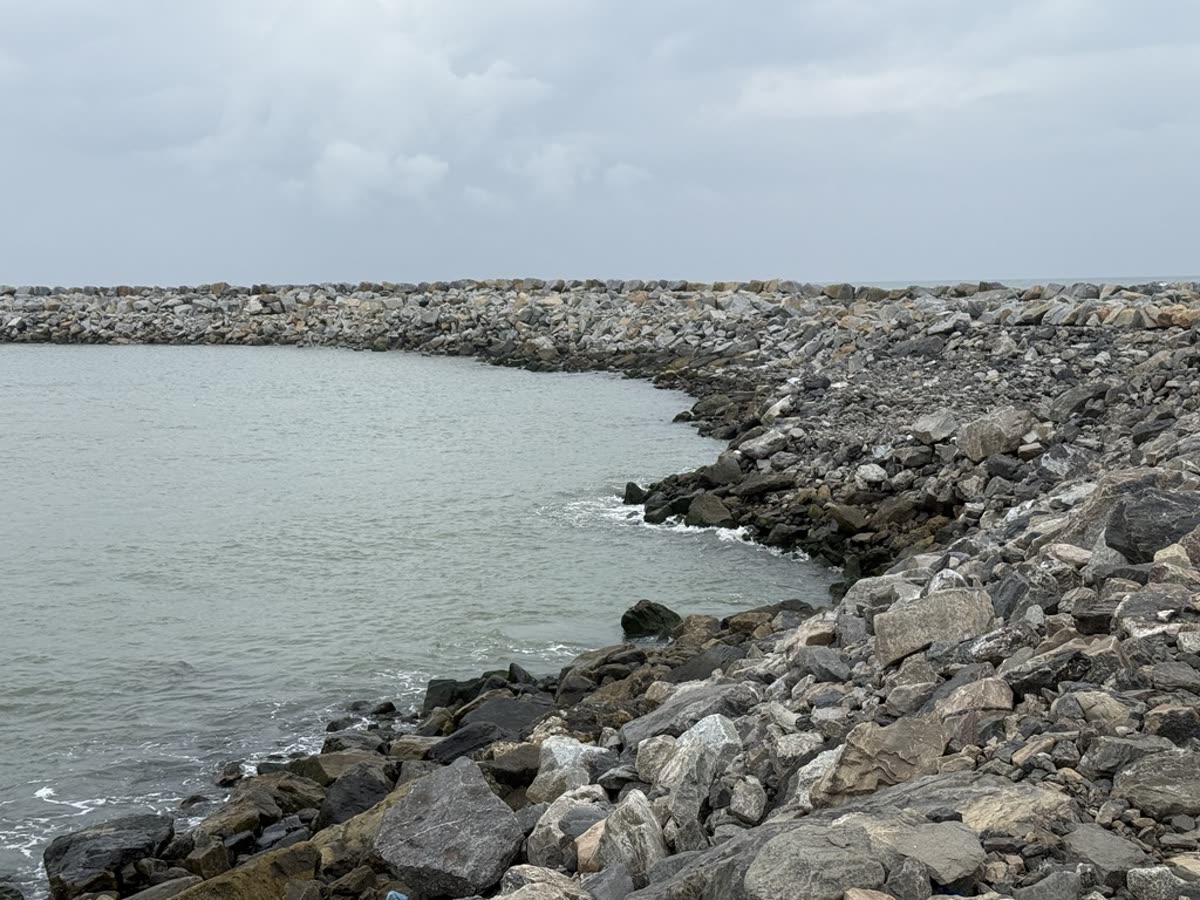 Curved riprap breakwater meeting the sea